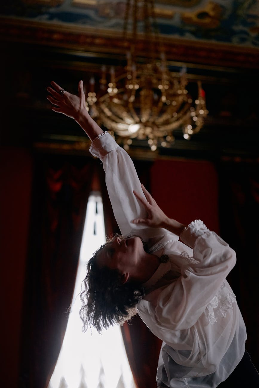 Man performing a controlled, gentle cardio movement in a dark room with amber lighting.